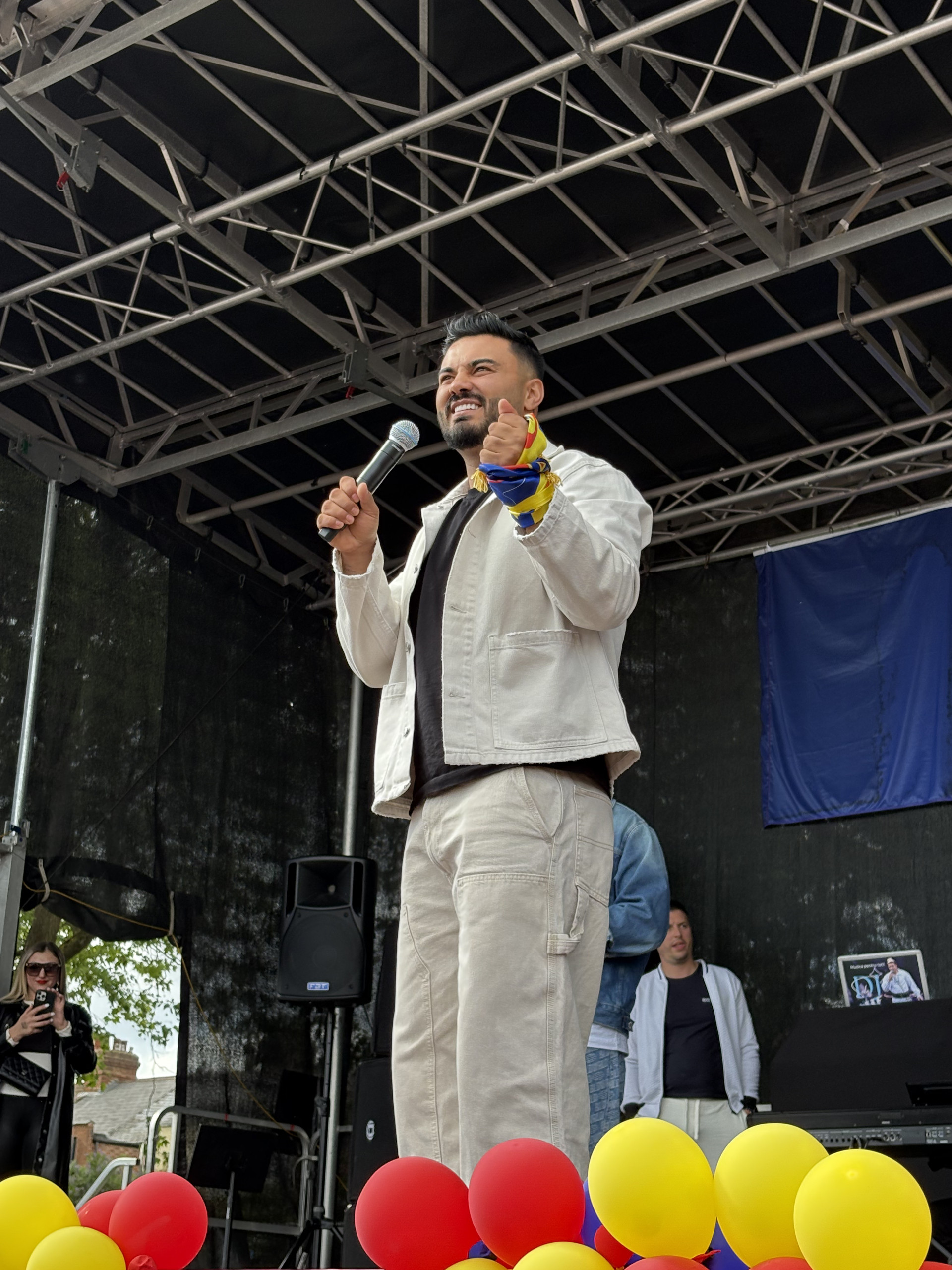 Jador on a stage with a microphone in his hand performing at a festival in London (Image 2)