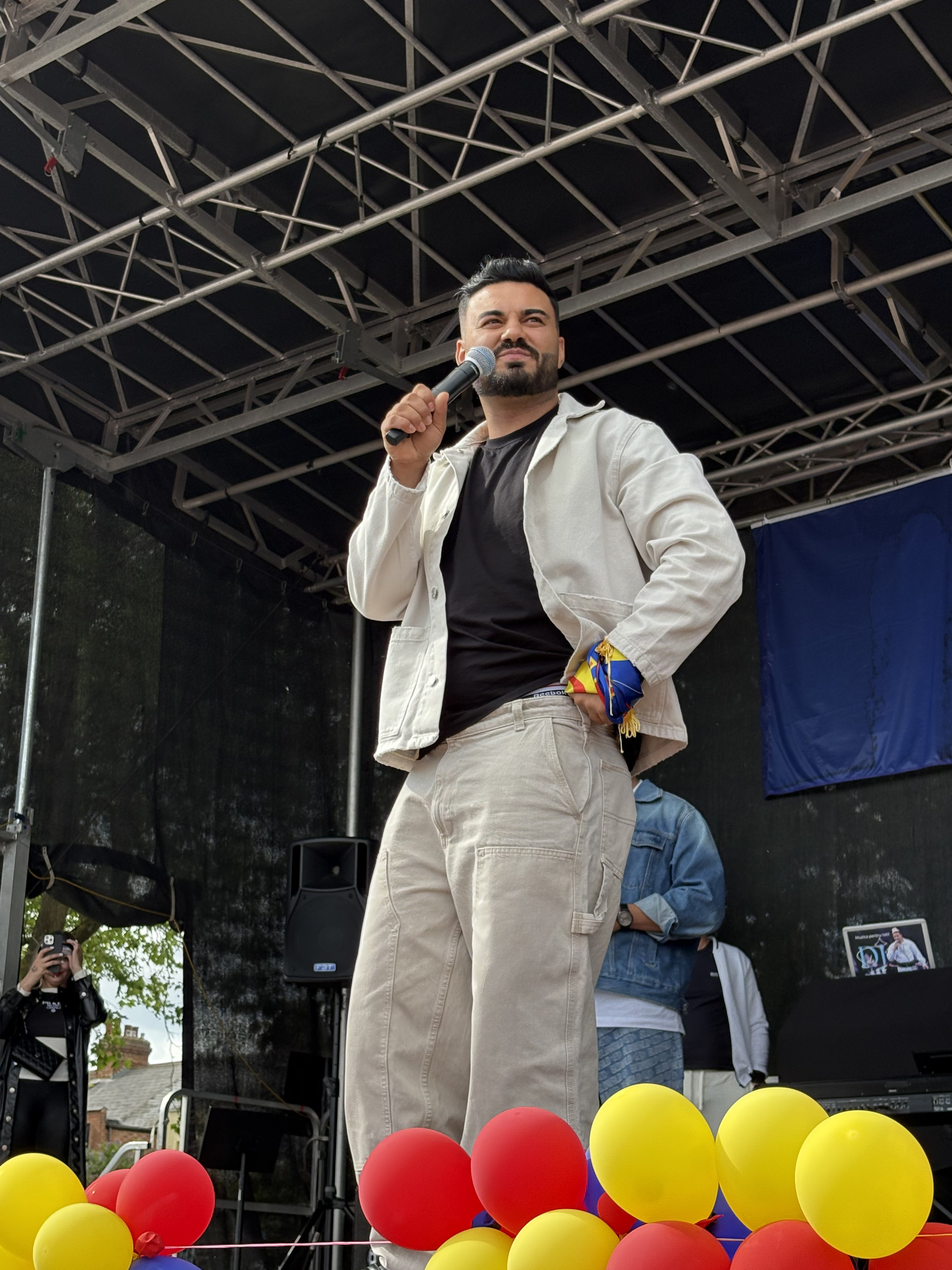 Jador on a stage with a microphone in his hand performing at a festival in London (Image 3)